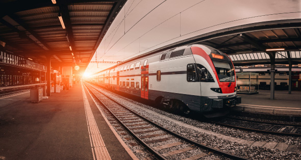 Long train standing on train station.